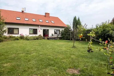 a house with a yard with green grass at Spacious house in the rural suburbs of Krakow in Zagacie