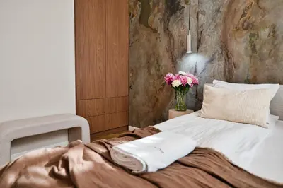 a bedroom with a bed with a vase of flowers at Jasmine Grand 7 by Housine in Zator