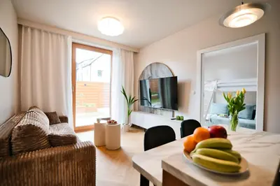 a living room with a table with fruit on it at Jasmine Grand 7 by Housine in Zator