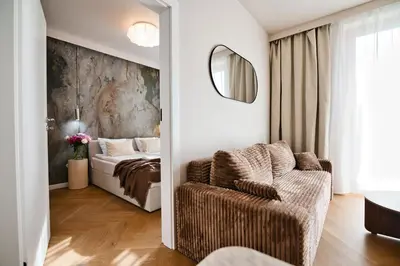 a bedroom with a bed and a couch and a mirror at Jasmine Grand 7 by Housine in Zator