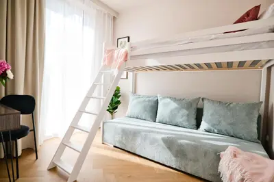 a white bunk bed in a small room with a ladder at Jasmine Grand 7 by Housine in Zator