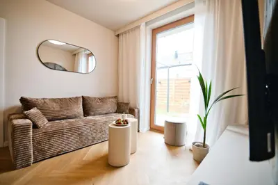 a living room with a couch and a mirror at Jasmine Grand 7 by Housine in Zator