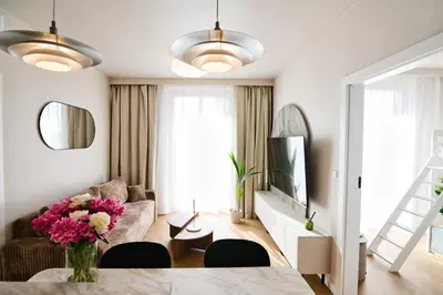 a living room with a table with a vase of flowers at Jasmine Grand 7 by Housine in Zator