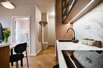 a kitchen with a sink and a counter with a chair at Jasmine Grand 7 by Housine in Zator