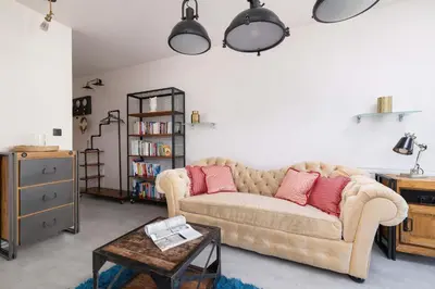a living room with a couch and a table at Żabiniec Stylish Apartment in Cracow with Balcony by Noclegi Renters in Kraków