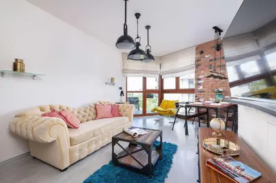 a living room with a couch and a table at Żabiniec Stylish Apartment in Cracow with Balcony by Noclegi Renters in Kraków