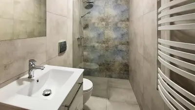 a bathroom with a sink and a toilet at Apartamenty w sadzie in Przenosza