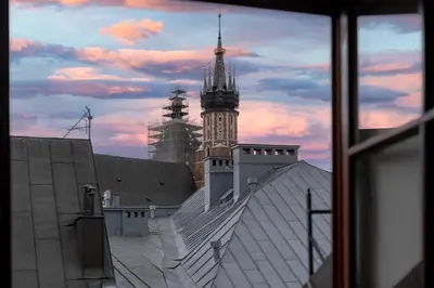 a view from a window of a building with a clock tower at Tomasza 20 Apartment in Kraków
