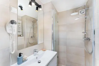 a bathroom with a shower and a sink at Tomasza 20 Apartment in Kraków