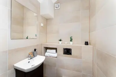 a bathroom with a sink and a mirror at Tomasza 20 Apartment in Kraków