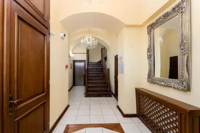 a hallway with a mirror and a staircase at Tomasza 20 Apartment in Kraków
