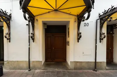 an entrance to a building with a brown door at Tomasza 20 Apartment in Kraków