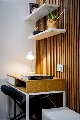 a wooden desk with a lamp on top of it at PAUL-IN-SKY Apartment Krakow in Kraków