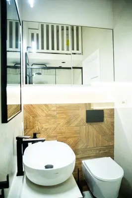 a bathroom with a white sink and a toilet at PAUL-IN-SKY Apartment Krakow in Kraków