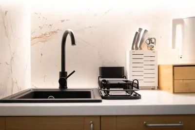 a kitchen counter with a sink and a appliance at PAUL-IN-SKY Apartment Krakow in Kraków