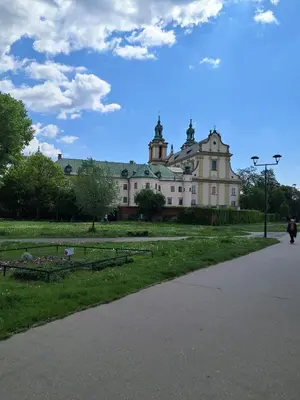 a large building in the middle of a park at PAUL-IN-SKY Apartment Krakow in Kraków