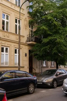 two cars parked in front of a building at Traugutta Loft in Kraków
