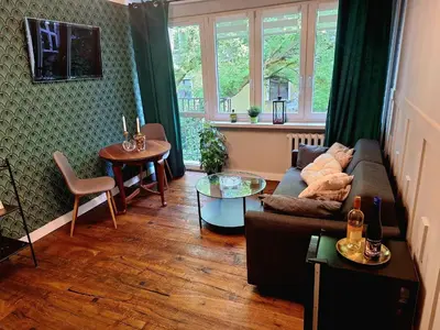 a living room with a couch and a table at Comfy Corners in Kraków