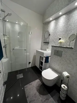 a bathroom with a toilet and a shower and a sink at Comfy Corners in Kraków