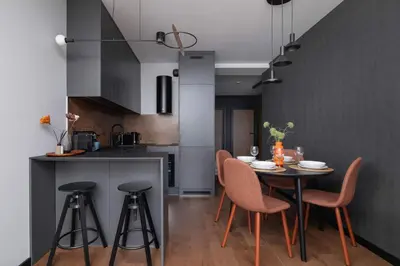 a kitchen and dining room with a table and chairs at Modern & Luxurious Apartment with Balcony & Parking Cracow by Renters Prestige in Kraków