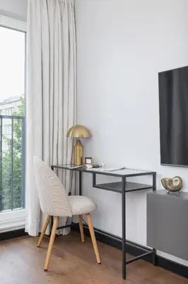 a desk and a chair in a room with a window at Modern & Luxurious Apartment with Balcony & Parking Cracow by Renters Prestige in Kraków