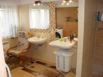 a bathroom with a sink and a toilet and a mirror at Noclegi u Zosi in Staniątki