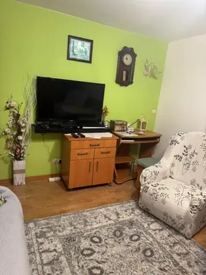 a living room with a desk with a television and a chair at Noclegi u Zosi in Staniątki