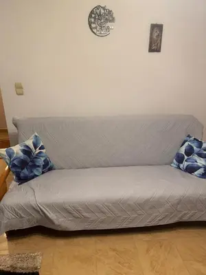 a couch in a room with blue pillows on it at Noclegi u Zosi in Staniątki
