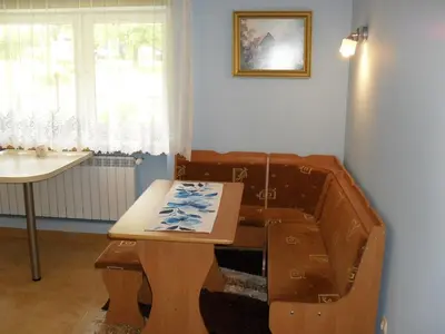 a wooden table in a room with a sink at Noclegi u Zosi in Staniątki