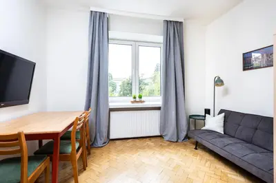 a living room with a couch and a table at Kazimierz Hideaway by Upstairs in Kraków