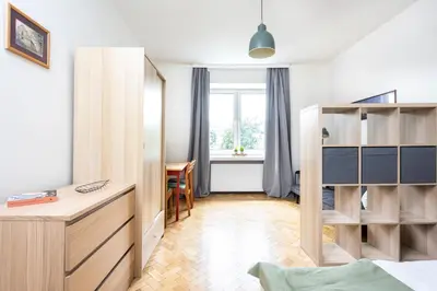 a bedroom with a bed and a desk and a window at Kazimierz Hideaway by Upstairs in Kraków