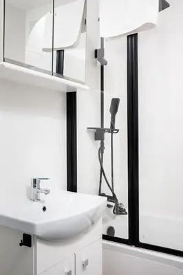a white bathroom with a sink and a mirror at Quiet Quarter - by Upstairs in Kraków