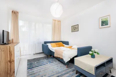 a living room with a bed and a tv at Quiet Quarter - by Upstairs in Kraków
