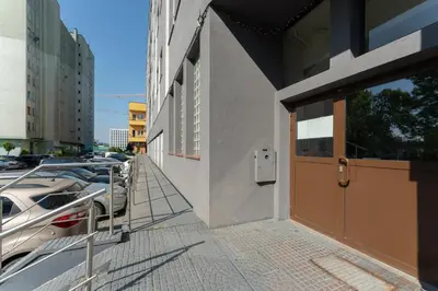 a building with cars parked next to a building with a door at Zakopiańska 2B Homely Apartment by BookingHost in Kraków