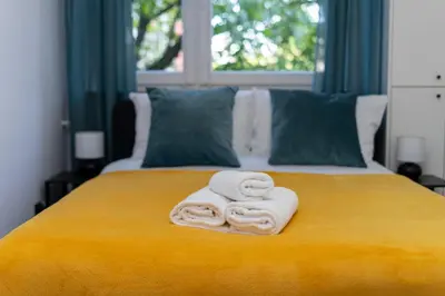 two towels sitting on top of a bed at Zakopiańska 2B Homely Apartment by BookingHost in Kraków