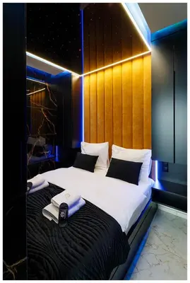 a hotel room with two beds with towels on them at Jacuzzi Glass-House Rakowicka 20 Central Station in Kraków