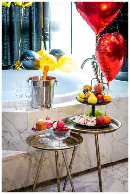 two tables with food and balloons on them at Jacuzzi Glass-House Rakowicka 20 Central Station in Kraków