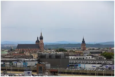 a view of a city with two tall clock towers at Jacuzzi Glass-House Rakowicka 20 Central Station in Kraków