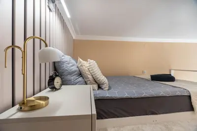 a small bedroom with a bed and a window at Apartament z Antresolą i Prywatnym Patio in Kraków