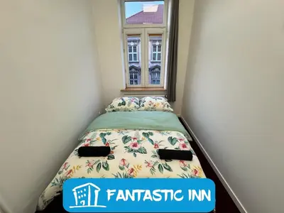 a small bedroom with a bed and a window at Fantastic-Inn Kraków - GR6 in Kraków