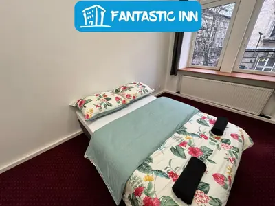 a small bedroom with a bed and pillows on it at Fantastic-Inn Kraków - GR6 in Kraków