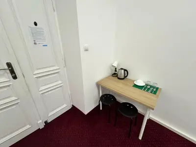 a small room with a desk and two stools at Fantastic-Inn Kraków - GR6 in Kraków