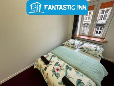 a small bedroom with a bed and a window at Fantastic-Inn Kraków - GR6 in Kraków