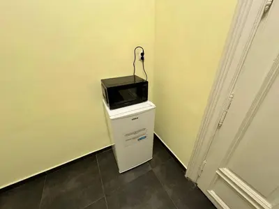 a microwave sitting on top of a refrigerator at Fantastic-Inn Kraków - GR6 in Kraków