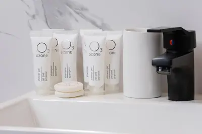 a shelf with four white cups and a coffee maker at Cozy Studios in the Old Town of Kraków by Noclegi Renters in Kraków