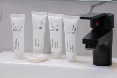 a group of four tubes of sunscreen next to a microscope at Cozy Studios in the Old Town of Kraków by Noclegi Renters in Kraków