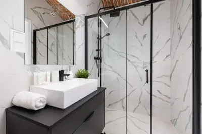 a bathroom with a sink and a shower at Cozy Studios in the Old Town of Kraków by Noclegi Renters in Kraków