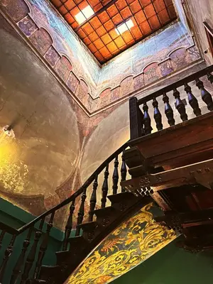 a spiral staircase in a building with a ceiling at The Heritage House Aparthotel Main Square Self Check-In in Kraków