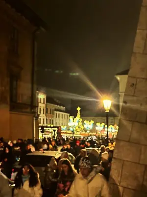 a crowd of people walking down a street at night at The Heritage House Aparthotel Main Square Self Check-In in Kraków