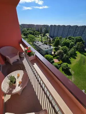 a balcony with a view of a city at Słoneczne mieszkanie wśród zieleni in Kraków